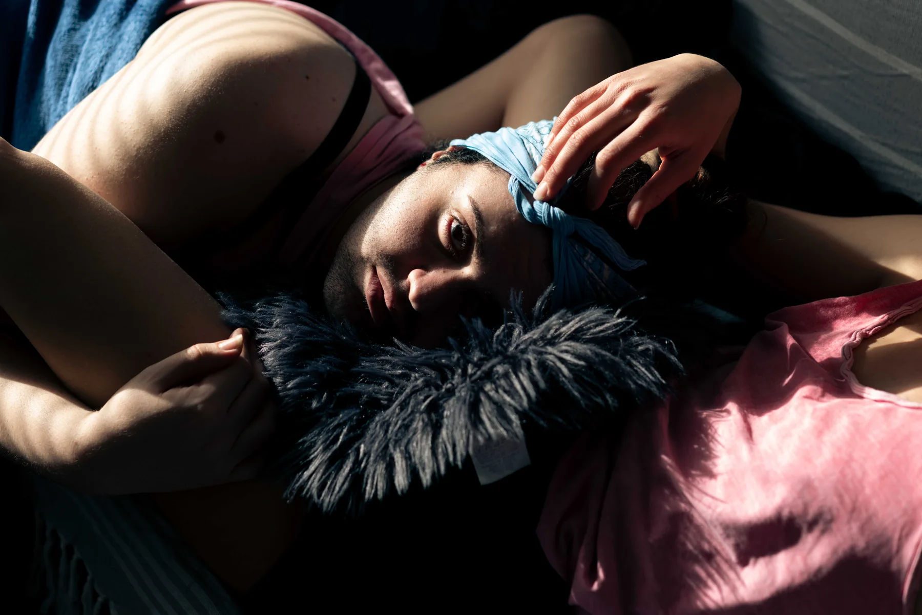 A person lies in soft light wearing a feather boa — the cover photograph of Come Get Your Honey.